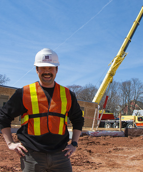 Project Mangement student, Matthew Doucette stands in front of the construction project.