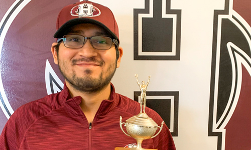 Pictured Top: Jorge Moreno poses with his PEI Closed Chess Championship trophy.