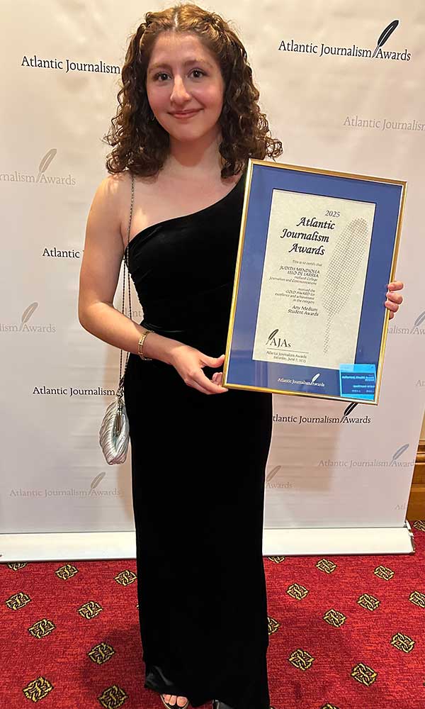 Judith poses with her 2025 Atlantic Journalism Award