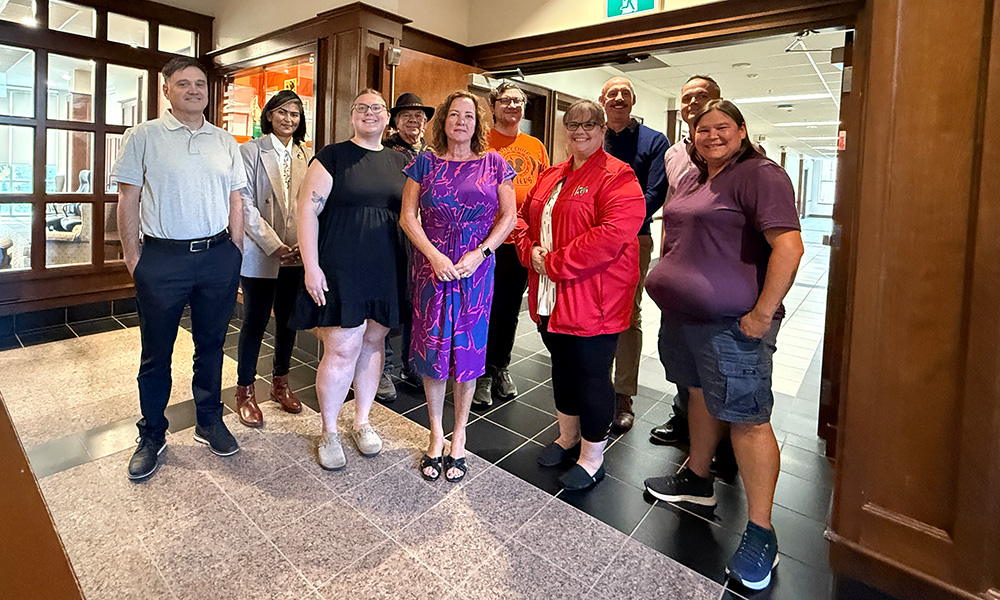 Members of the Indigenous Advisory Committee stand together for a group photo